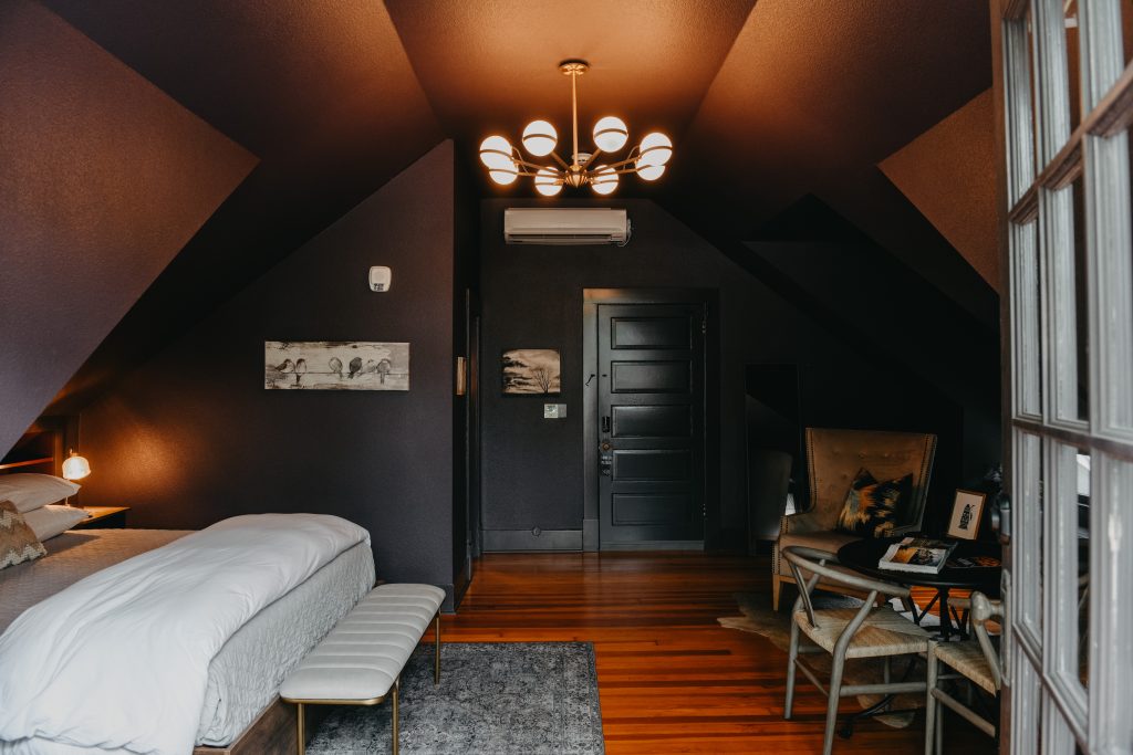 Chair, bed, and lighting in bedroom at Sophie's Gasthaus