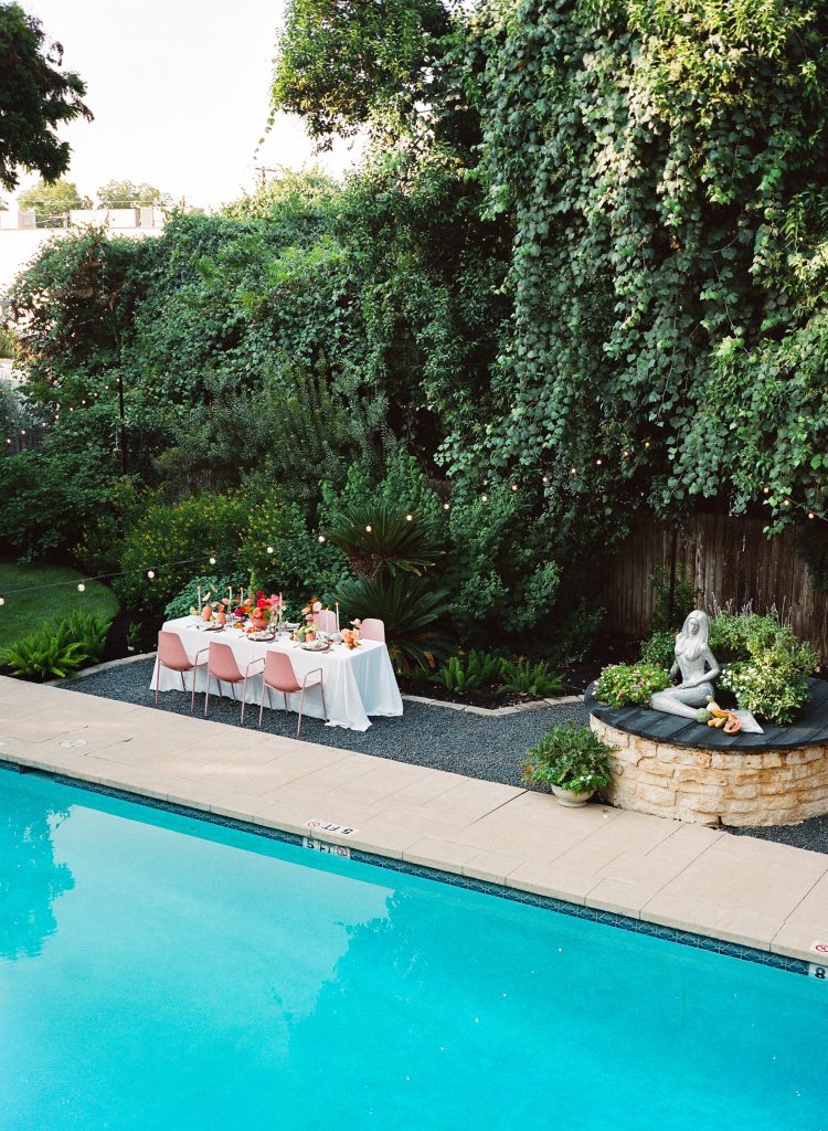 Lights above pool for intimate ceremony